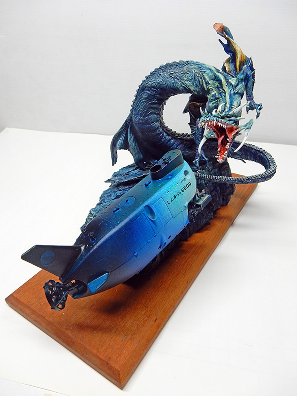 Diorama d'un sous-marin bleu attaqué par un dragon marin sur socle bois
