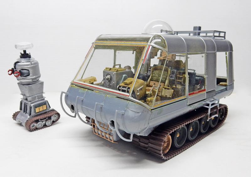 Maquette de chariot chenillé avec verrière vitrée accompagné d'un robot argenté miniature