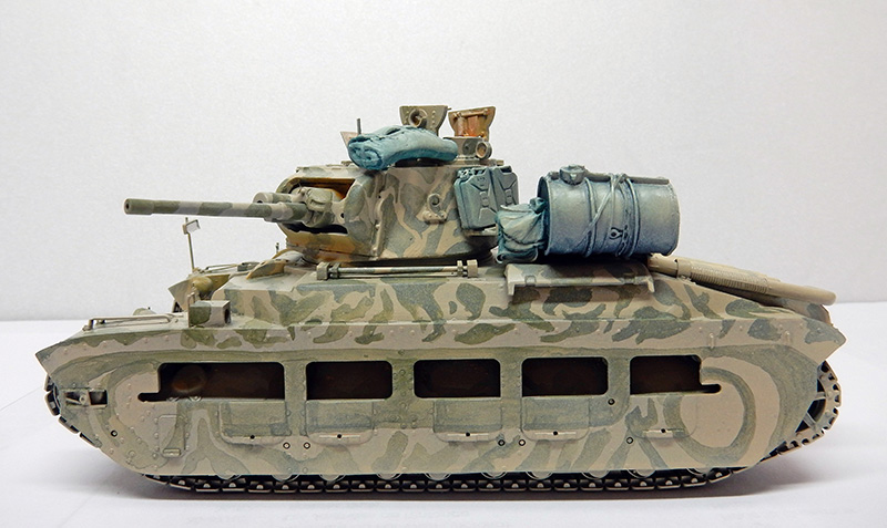 Maquette de char britannique Matilda II camouflé vu de profil avec barils et paquetage sur le toit