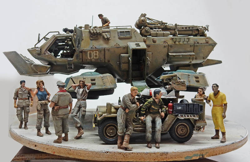 Maquette de diorama avec véhicule blindé futuriste suspendu, jeep et nombreux personnages militaires autour