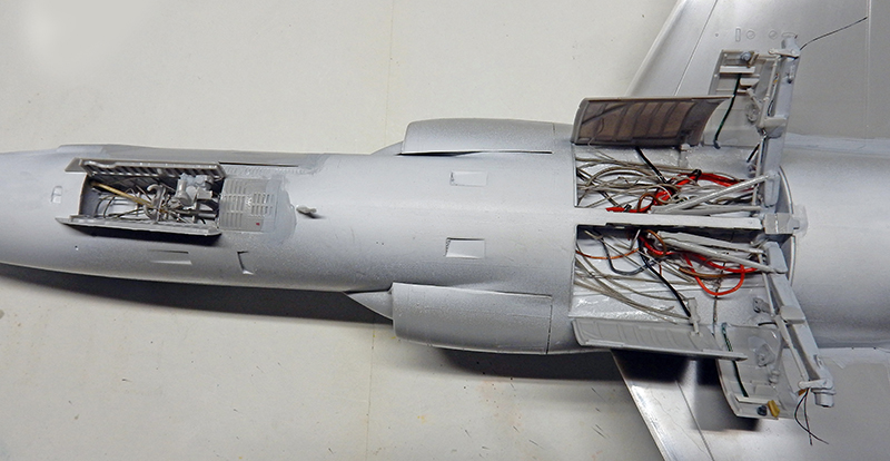 Fuselage de F-104 en montage, trappes ouvertes sur câblages et équipements électroniques détaillés