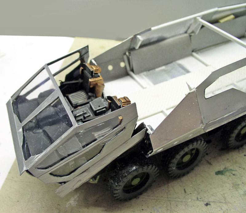 Maquette de véhicule blindé à six roues avec habitacle ouvert montrant les sièges détaillés