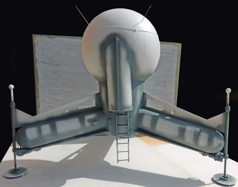 Maquette grise du vaisseau spatial G.N.U. avec coque sphérique, ailes et échelle d'accès