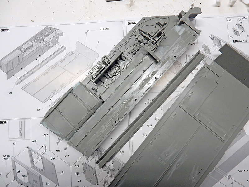 Coque grise du M113 ACAV en cours d'assemblage posée sur la notice de montage