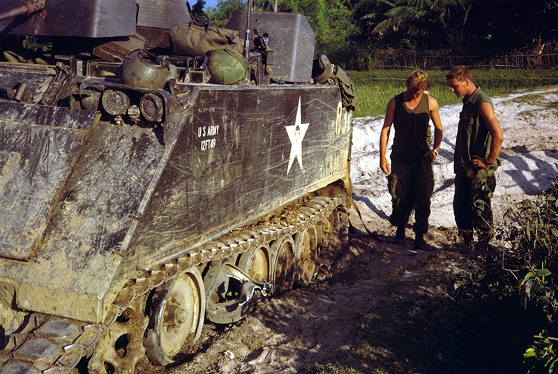 Blindé chenillé M113 ACAV de l'US Army avec deux soldats dans la jungle