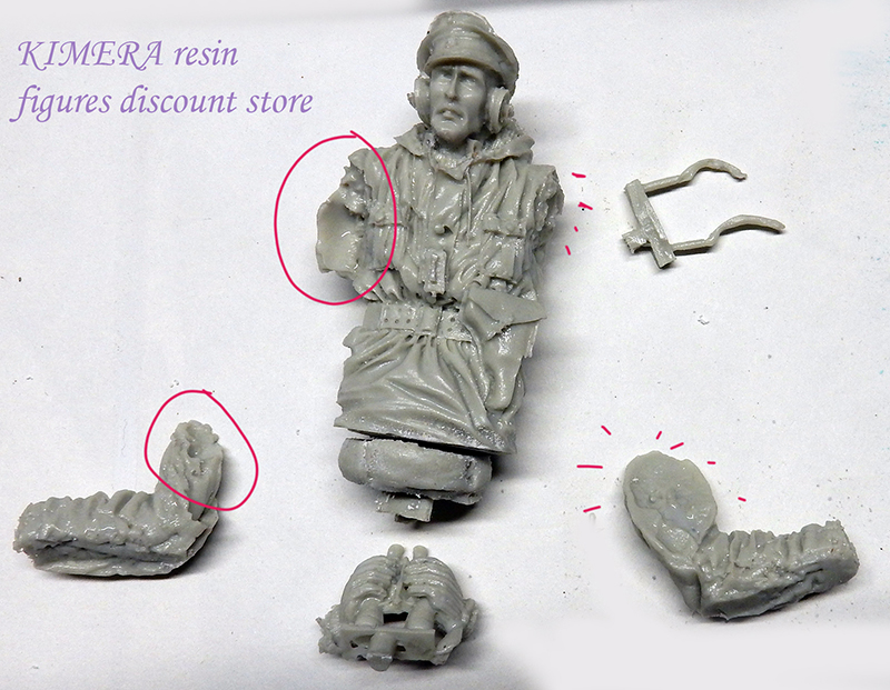 Pièces en résine d'une figurine de tankiste avec zones de retouche entourées en rouge