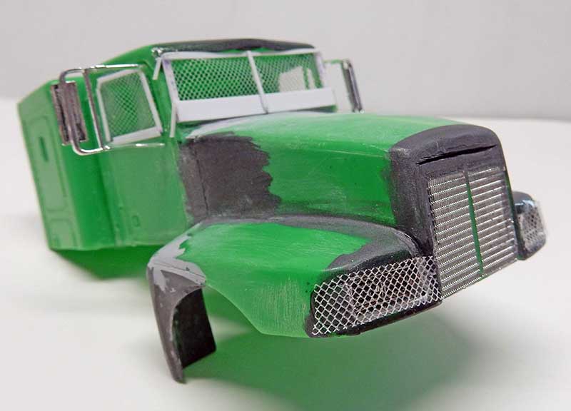 Cabine de camion maquette peinte en vert avec calandre et grilles métalliques, ombrages noirs