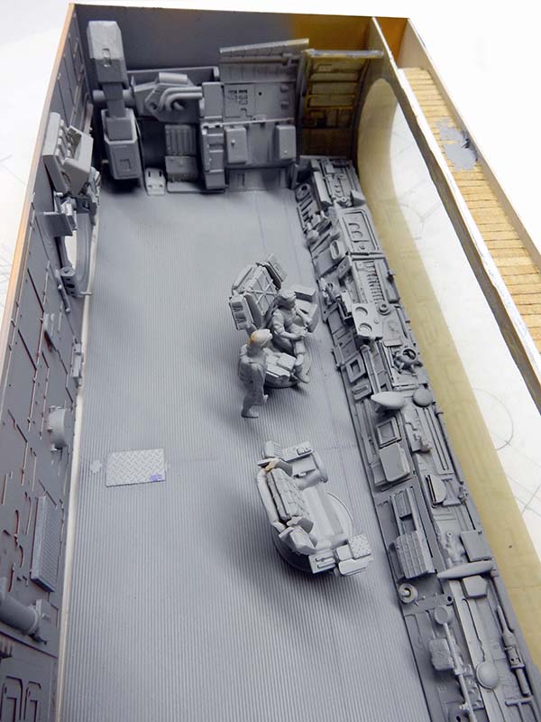 Intérieur du cockpit de l'astronef en apprêt gris, sièges, consoles et figurines assemblées
