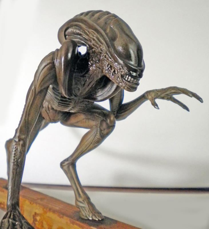 Maquette peinte du xénomorphe d'Alien 3 accroupi sur une poutre, griffes tendues