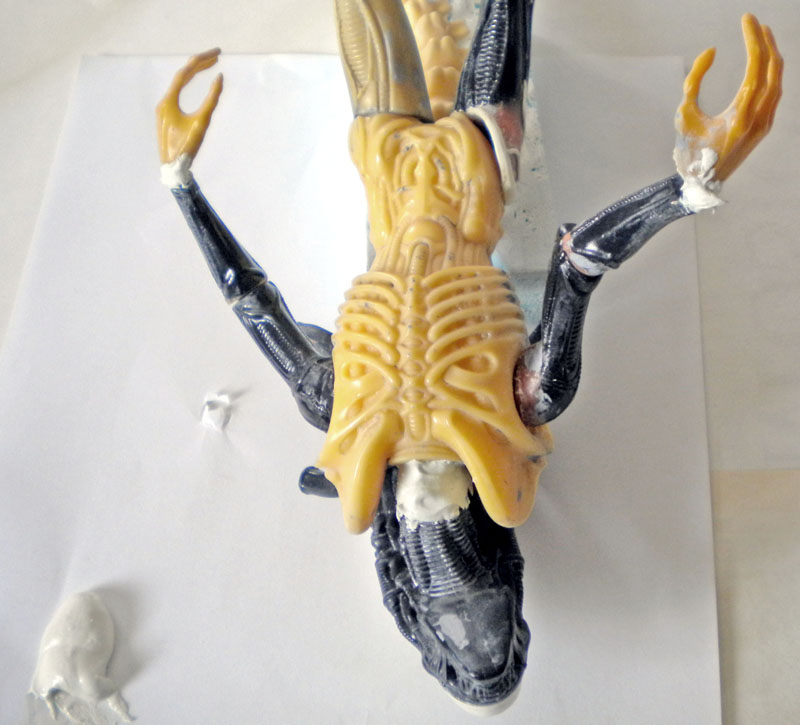 Maquette d'Aqualien en cours d'assemblage montrant le buste beige et les membres gris avec mastic