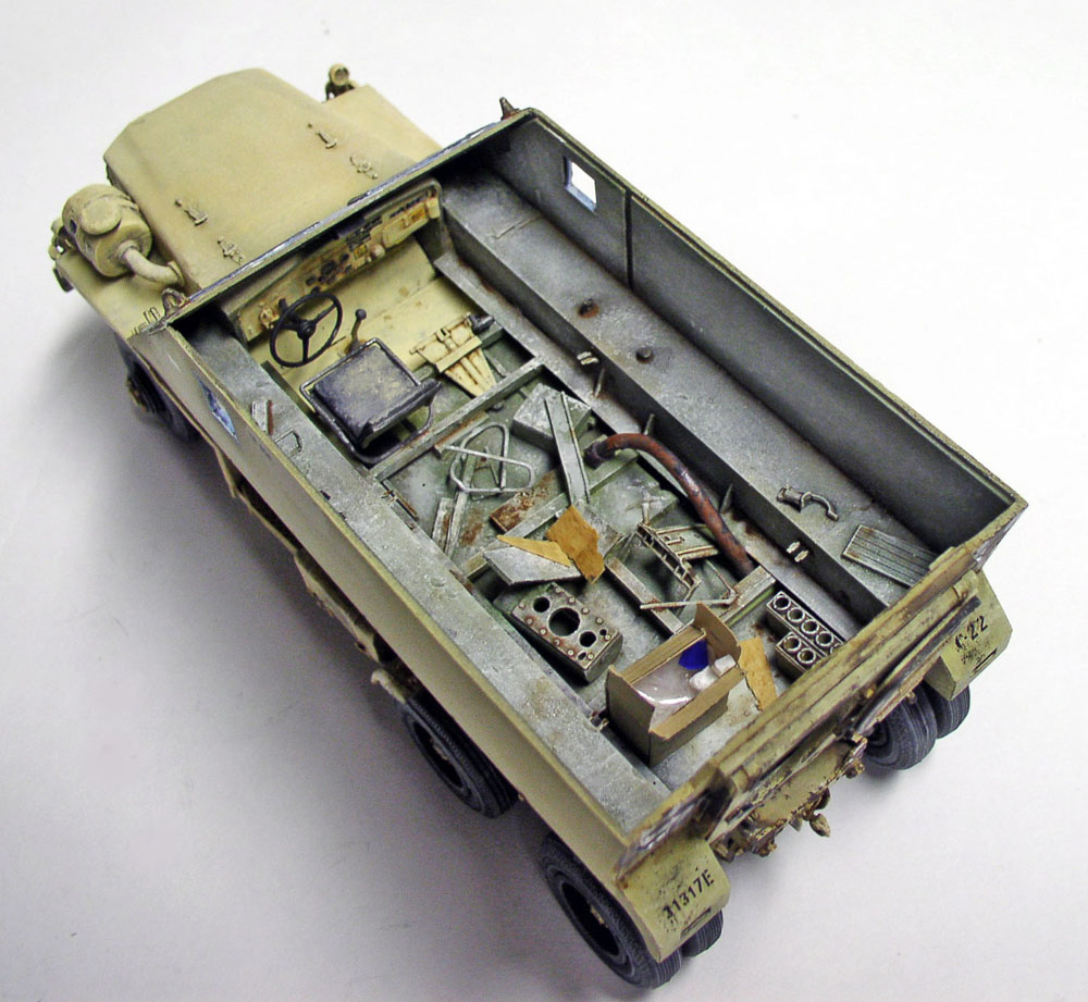 Maquette de camion militaire sable avec benne ouverte montrant intérieur détaillé et équipements