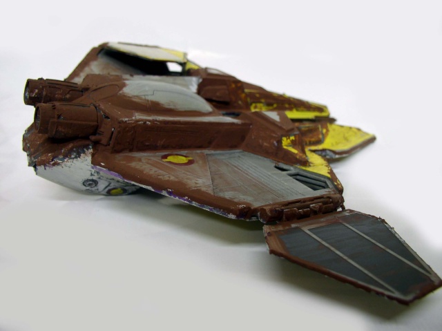 Maquette de vaisseau spatial peinte en marron et gris avec aile latérale sombre