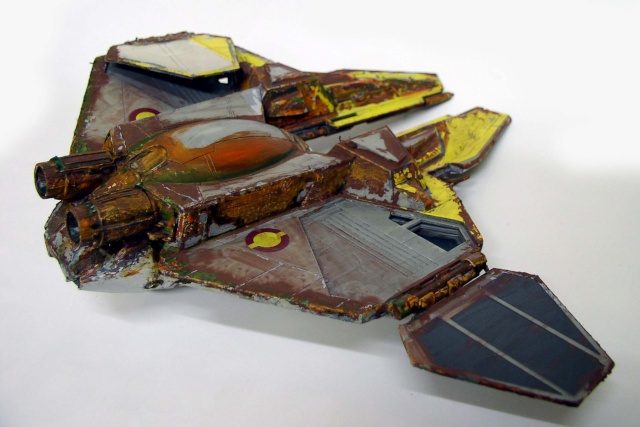 Maquette de chasseur spatial Jedi vieilli, peinture rouille et jaune, cockpit orange, fond blanc