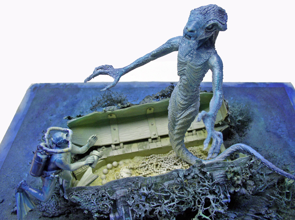 Diorama d'un démon marin menaçant un scaphandrier près d'un coffre au trésor englouti