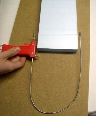 Découpe d'un bloc de polystyrène extrudé à l'aide d'un coupe-fil thermique rouge