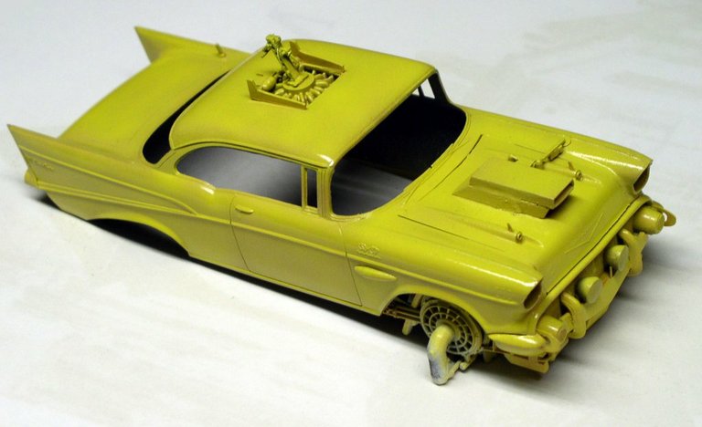 Maquette de Chevrolet jaune modifiée en véhicule spatial avec ailerons et éléments ajoutés sur la carrosserie