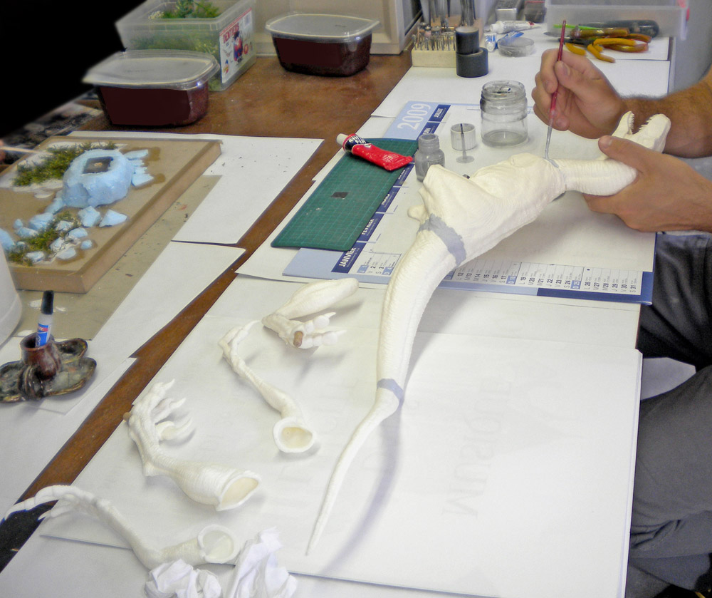 Velociraptor en maquette détaillée posé sur un socle de présentation