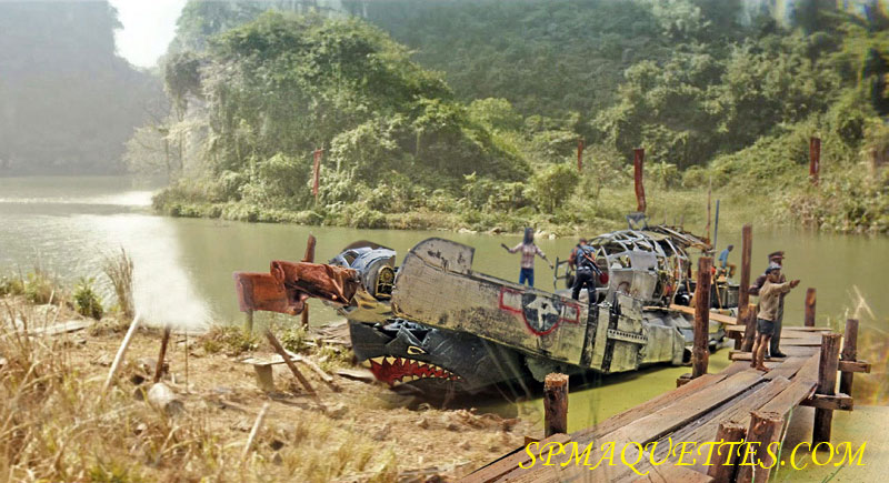 Diorama d'un bateau fabriqué avec une épave d'avion militaire amarré près d'un ponton sur une rivière