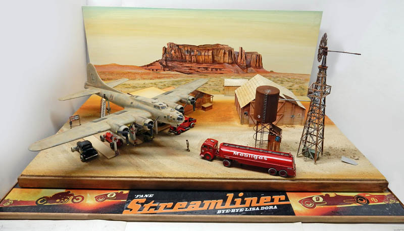 Diorama désertique avec bombardier B-17, camion-citerne Mobilgas rouge et château d'eau devant des mesas